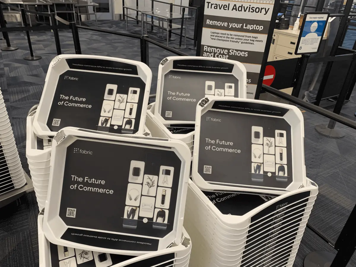 TSA security tray advertising at an airport checkpoint